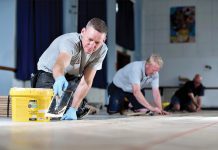 Levelling compound and adhesive combinations for installing wood floorcoverings